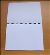 Place the paper so that the short ends are at the top and bottom.
Bring the bottom up to the top to fold the paper in half.