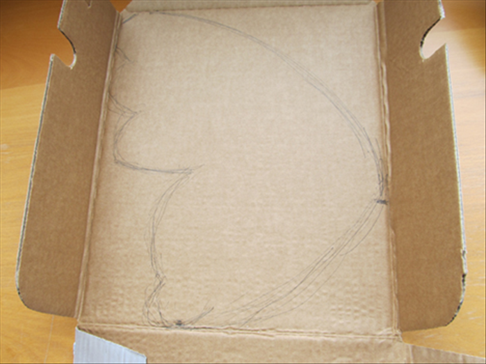Open up the soda carton

Draw a wing shape on one of the large sides of the carton
Cut out the wing shape
