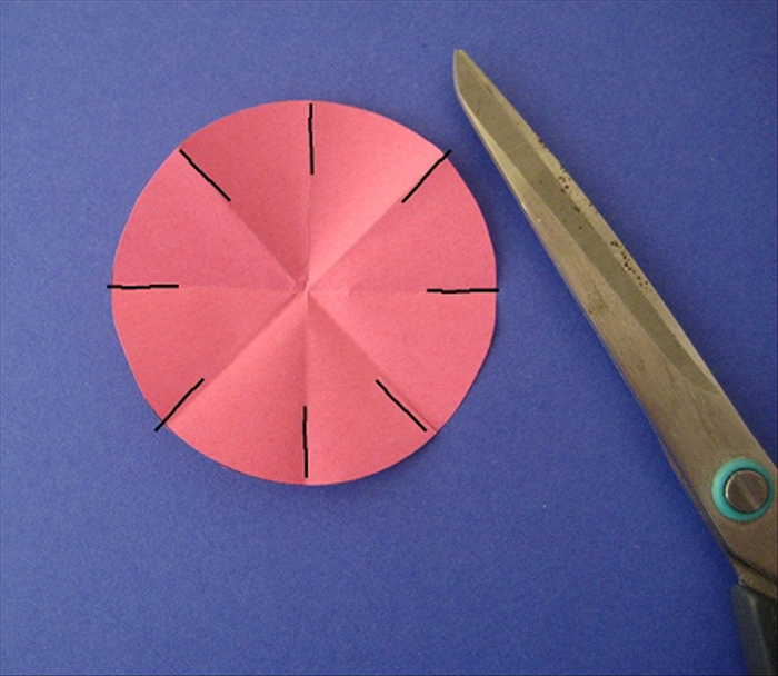 Unfold. 
Cut slits on each crease about ½ way down.