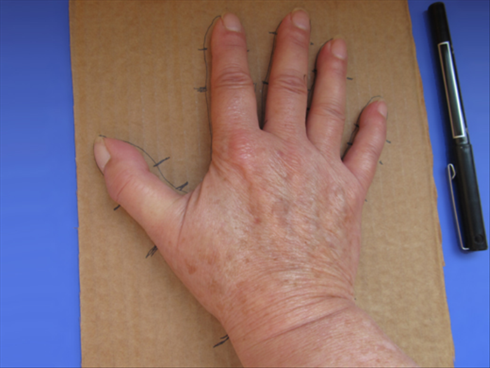 Trace the outline of your hand.
Make marks next to all the finger joints.
Remove your hand
Mark the joints inside the outline of the hand
Cut out the hand
