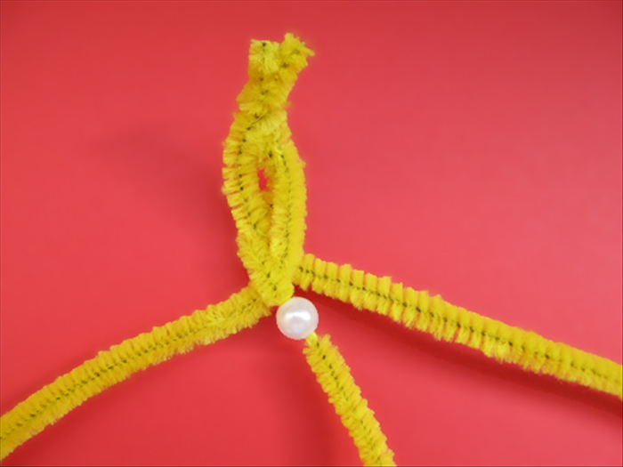 Slide a bead up from the end of the middle pipe cleaner