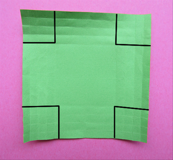 Cut out a 4 by 4 squares at each corner
