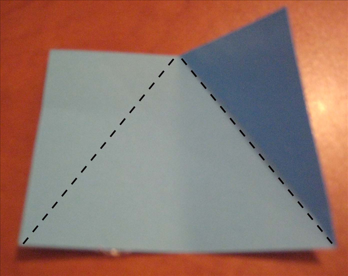 Fold from the pinch mark to the right bottom edge.

Fold from the pinch mark to the left bottom edge.
