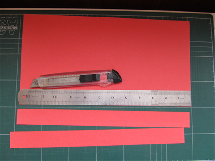 Cut strips of paper 1 ¼ inches wide
Here the 1 ¼ inch width of the ruler was used for the width of the strips
