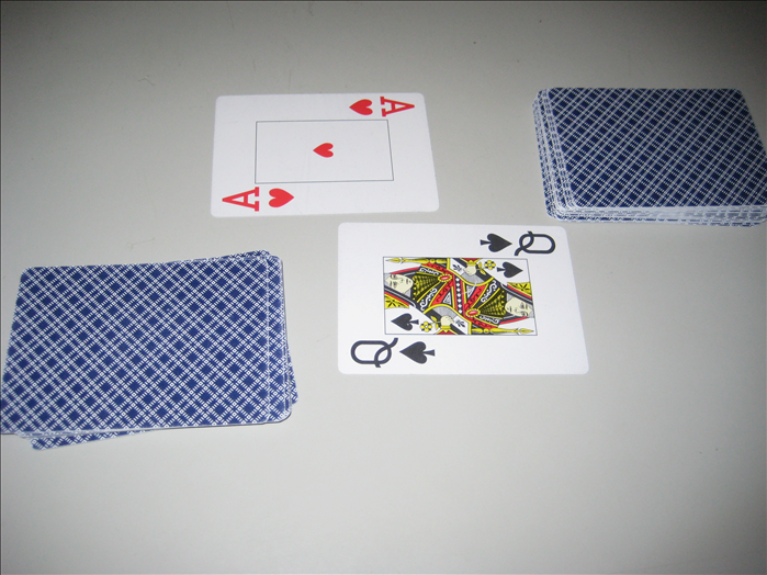 At the same time, all of the players take a card from top of  their stacks and put it face up in the center of the table.

The player who put the highest card takes all the cards in the center of the table.