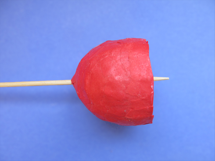 Now we will use baking foil to make the ball and loop for hanging the bell.
If you want to use bead on a string or wire, skip to step 19 and just thread it through the hole.

Push the point of a skewer through the hole to make it bigger.
