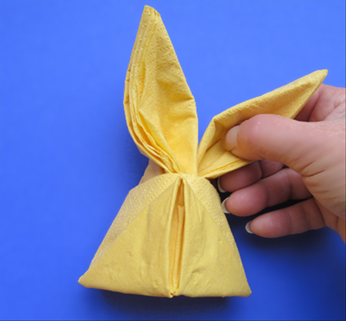 Turn the napkin to the front
Spread the layers at the center a little
Shape the ears
