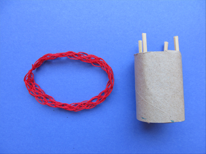 Materials:
1 toilet paper roll
Barbeque sticks, toothpicks or ice cream popsicle sticks
Ruler
Scissors
Tape 
Rubberband
White glue
Thread or wool
