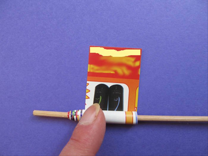 Roll up the strip on the stick. Put glue on the end.