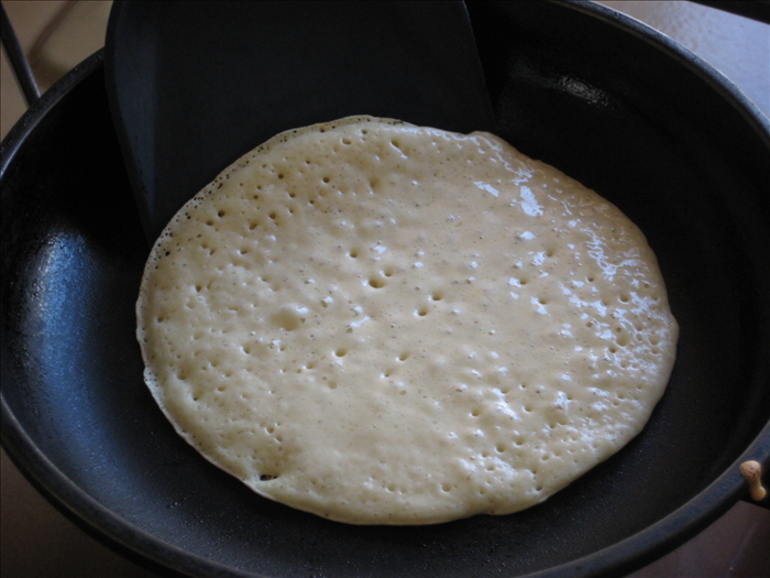 Cook until bubbles form at the top and the bottom is lightly browned