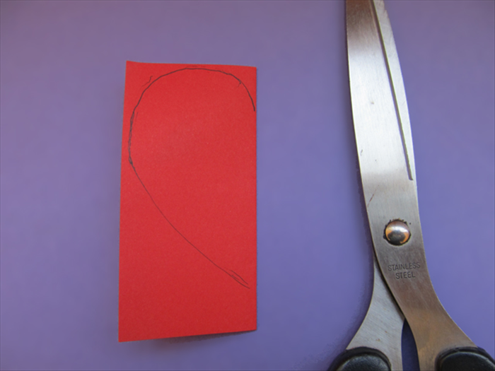 Cut a half heart shape from the folded edge