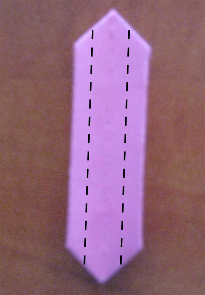 Turn the pink papers over to the back side.
Fold the sides to the center. 
Do this to only to the pink papers.
