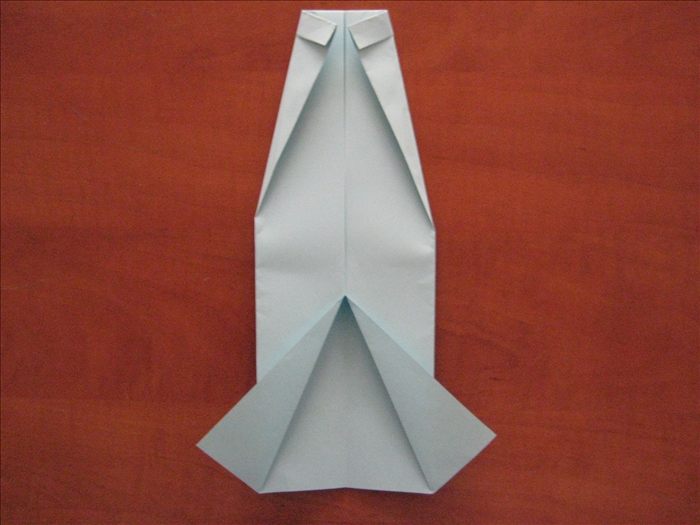Flip the paper over again.

Fold the 2 top corners diagonally so that they meet in the center.
