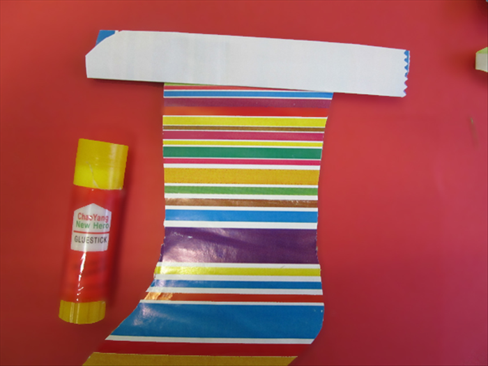 <p> Flip the paper over and glue it to the top of the stocking.</p> 
<p>  </p>
