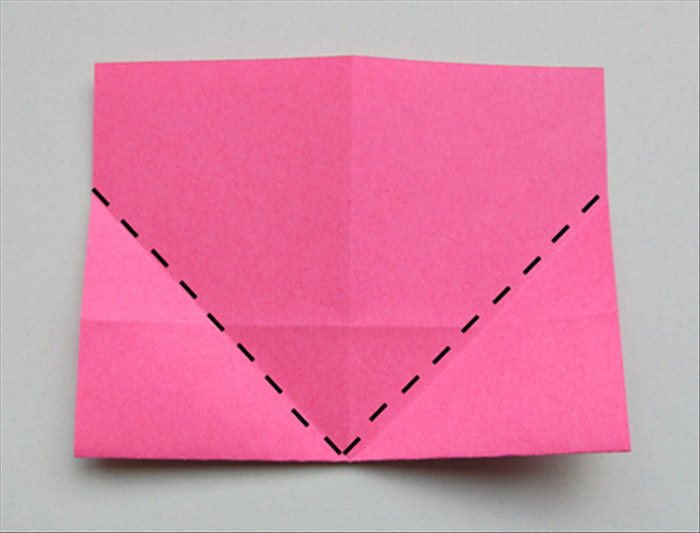 Flip the paper over to the back.

Fold the bottom edges up to the center crease
