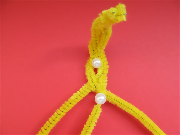 Slide a bead up from the end of the middle pipe cleaner