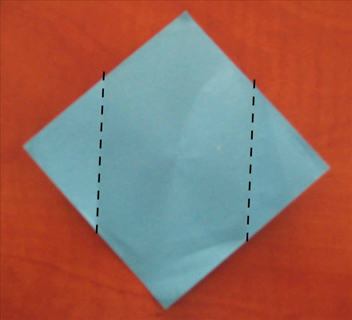 Fold  the side points to the center pinch mark you just made.