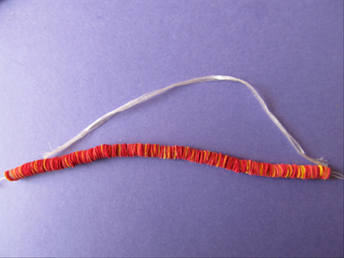 Continue stringing the circles until you have the length of the string you measured in step 2