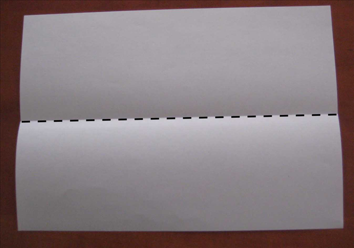Place the paper with the short edges at the sides.

Fold it in half horizontally.
Unfold