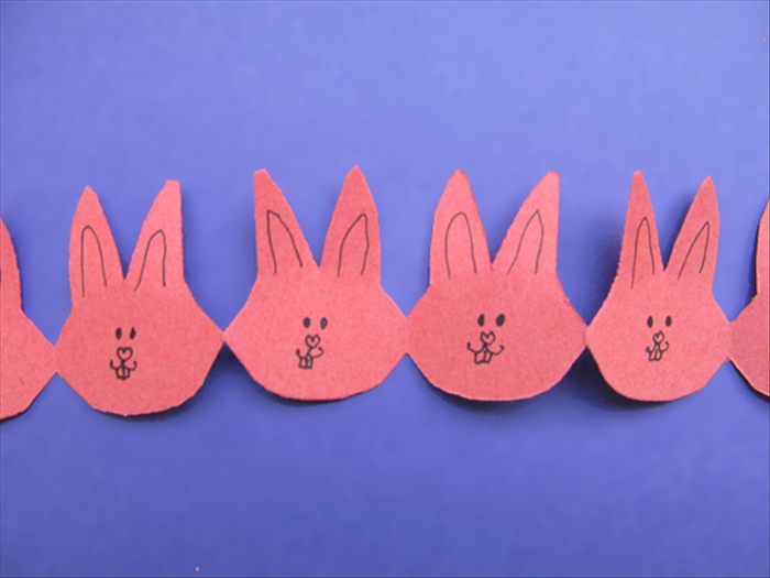 Unfold to see your bunny chain
Have fun drawing or decorating the faces!
