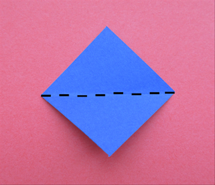Hold the paper so that the points are at the top, bottom and sides.
Fold in half horizontally. 
Unfold.