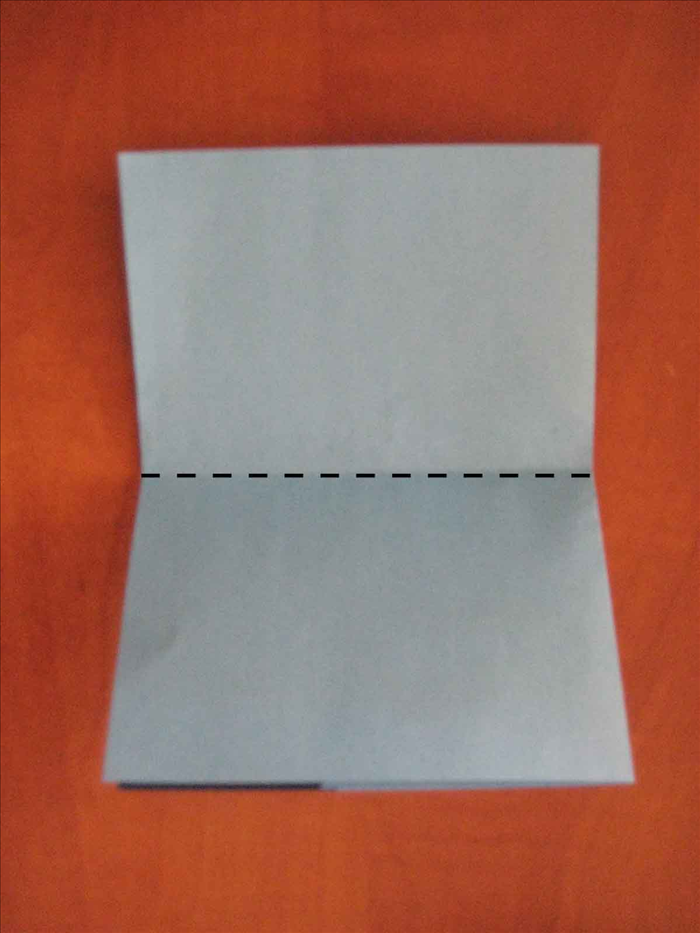 Rotate the paper so that the folded edge is on the left side

Bring the top edge down to the bottom to fold in half.
