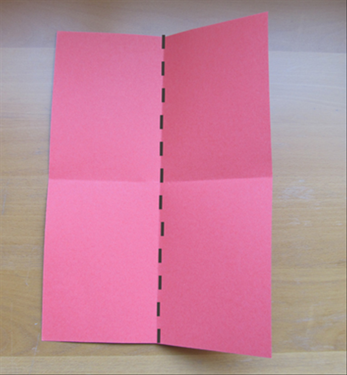 Fold the paper in half lengthwise.