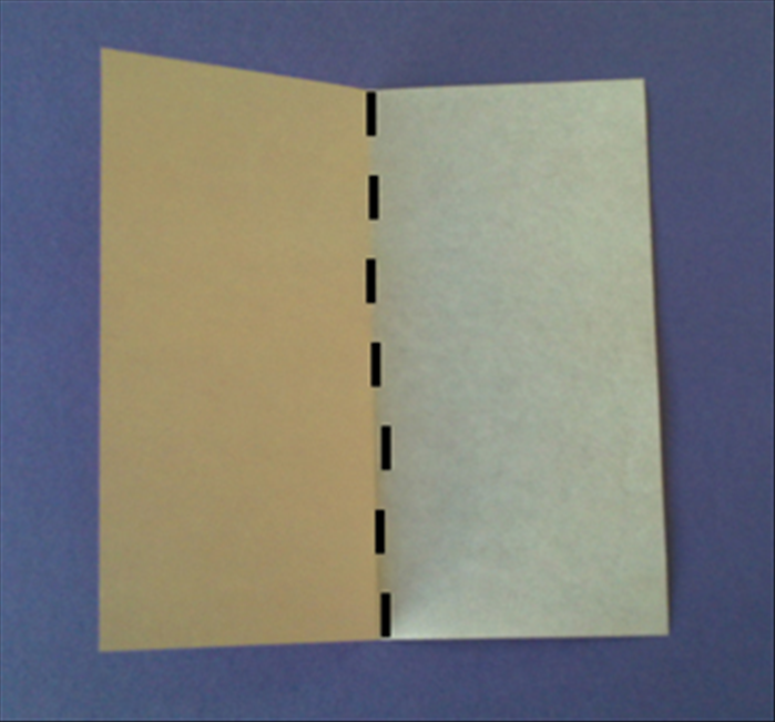 Place the colored side facing down on the table
Fold the paper in half vertically and unfold
