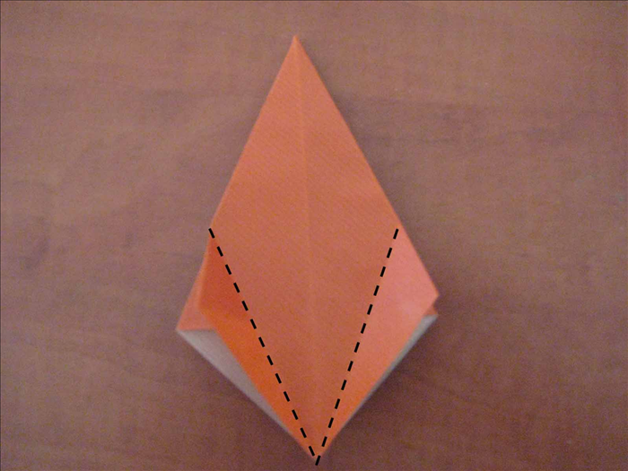 With the open end at the bottom, fold the side points so that the edges aligns with the middle crease.

Turn over and repeat on the back.
 Book fold  the front and back and repeat on the 2 remaining layers
