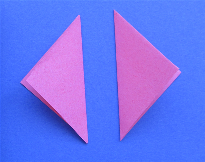 Cover one triangle with glue.
Align the second triangle so that all the points align and press in place

Glue a third triangle on top
