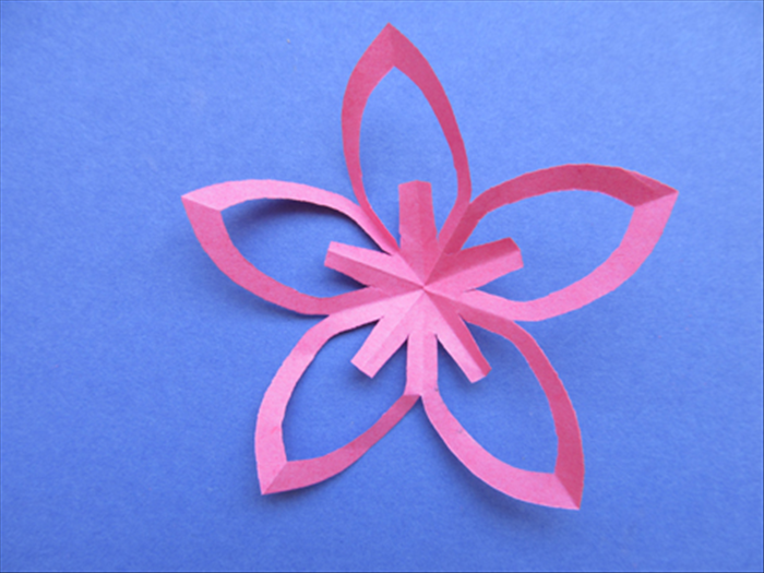 Very carefully unfold the paper to see your kirigami flower