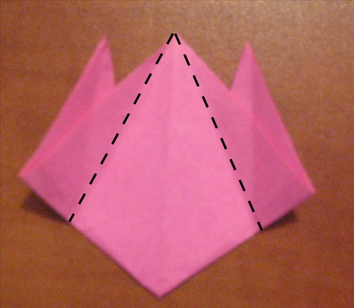  Make a fold from the top middle point to the bottom of the 2 creases you just made in the last step