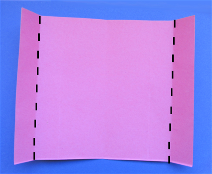 Fold the left and right edges to the crease marks you just made in the last step. 
Unfold