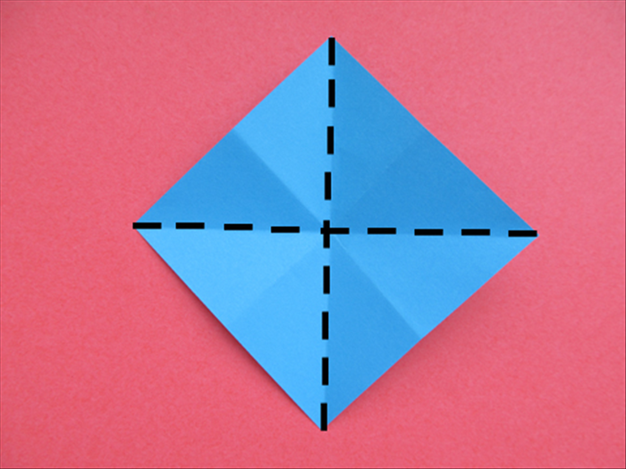 Flip the paper over to the back side with the points at the top, bottom and sides.

Bring the 2 side points together to fold it in half. Unfold
Bring the top and bottom points together to fold it in half. Unfold
