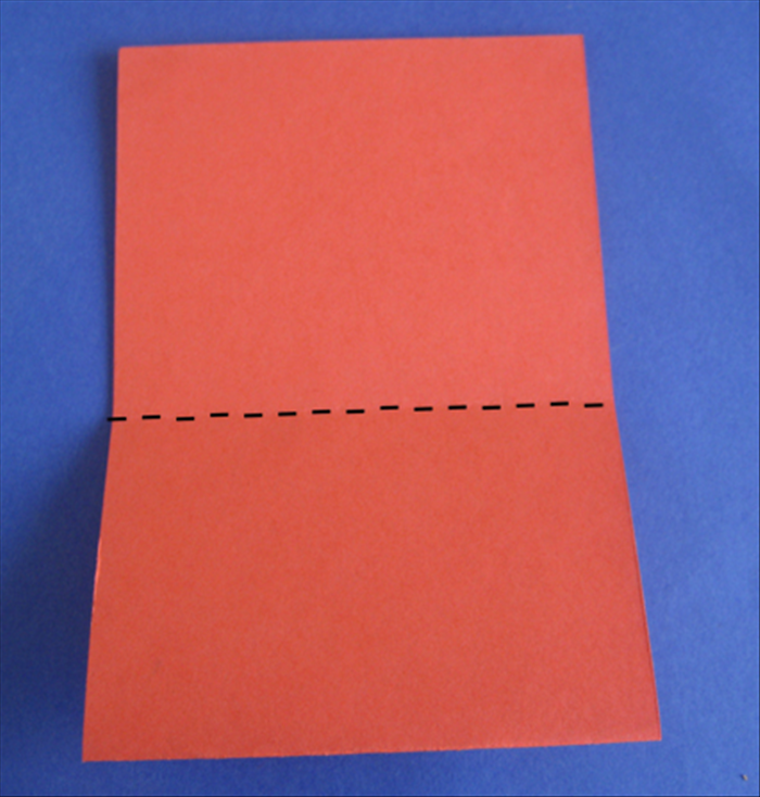 Turn the paper so that the open part is at the top

Fold down the top layer at the crease. Press down on the crease to make it sharp- then unfold

Flip the paper to the other side and repeat
