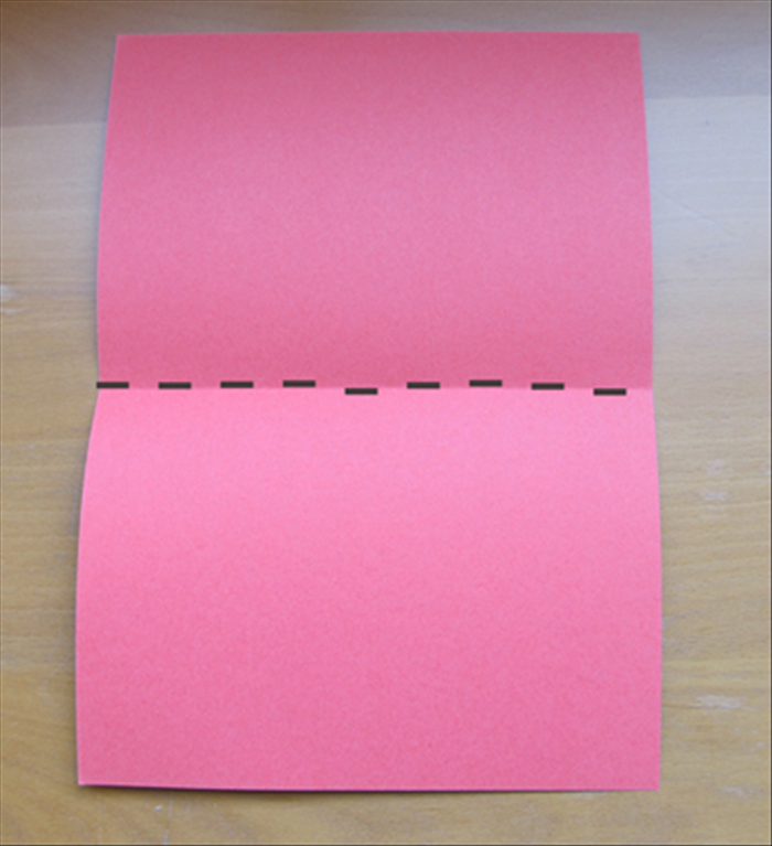 Fold your card paper in half widthwise and unfold.