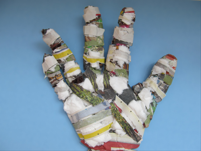 Continue adding toilet paper and covering it with newspaper strips.
When you are finished flip the hand over to the back and repeat steps  11 – 15
*The knuckles are the highest areas on the other side. They do not need as much padding as the palm.
