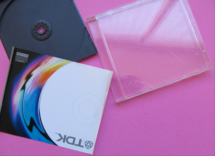 Remove the papers and plastic from the CD case.