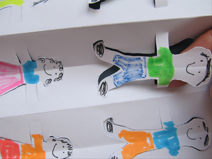 Stick your finger under each figure and press the ends of the arm to fold them against the paper