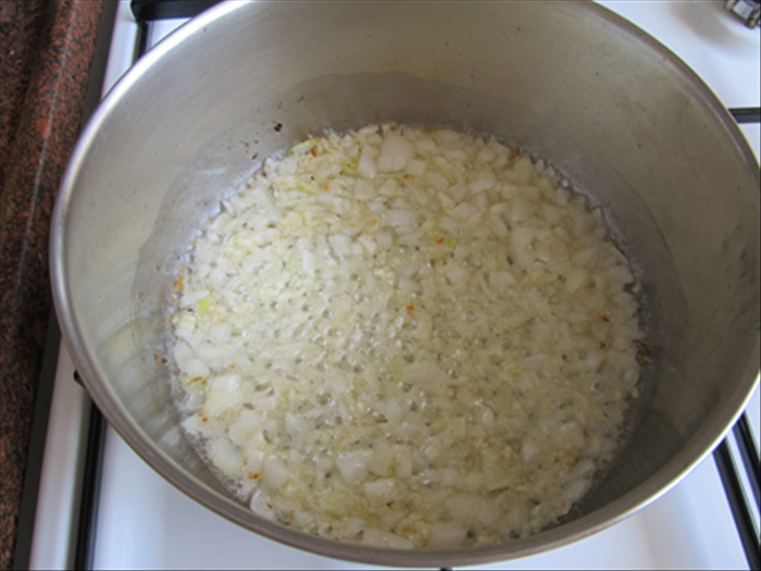 Melt the butter or margarine in a pot over a medium flame.
 Add the chopped onions and fry until soft and golden.
Add the minced garlic and fry another minute
