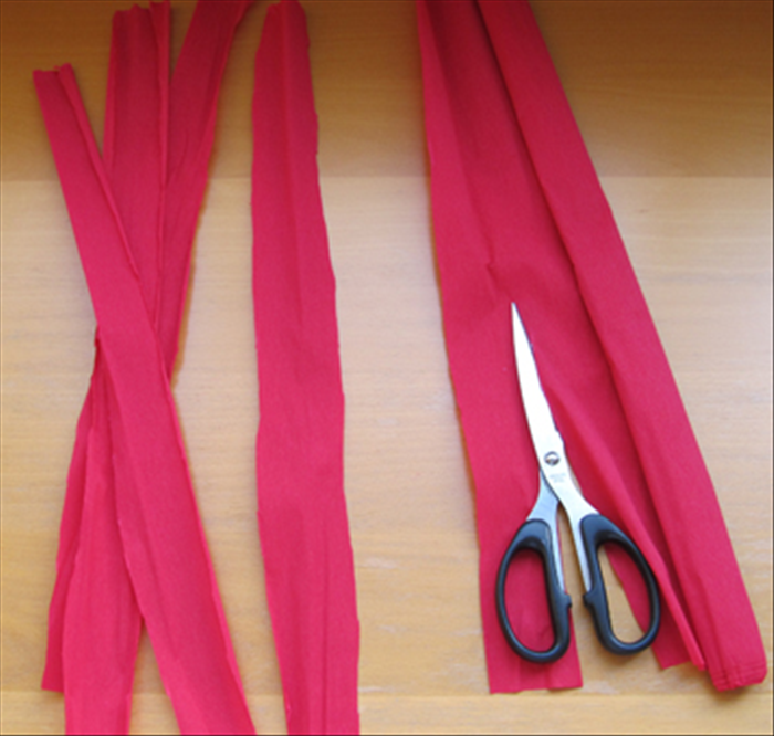 Cut  1.5 inch wide strips with the lines of the crepe paper going up and down. 
You will need 3 strips for each flower