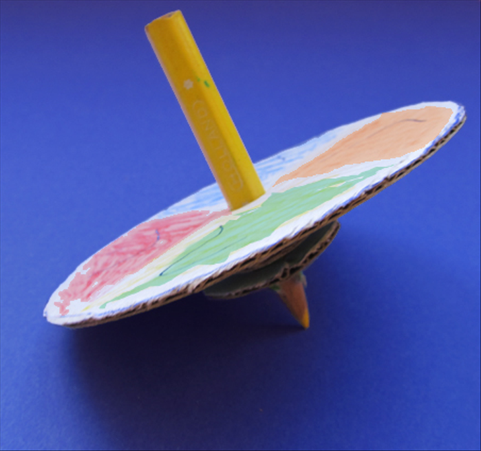 To make a dreidel from a pencil you will need:
Cardboard
A short pencil
Colors such as magic markers or colored pencil
Scissors
Scrap paper
A bottle cap and coffee cup or similar sized round object to trace circles
