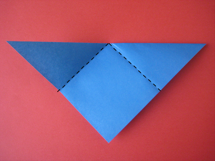 The long edge should be at the top.
Fold the 2 top points down to the bottom center point.
