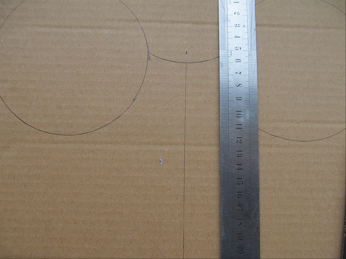 Draw a vertical line from the mark to the bottom of the cardboard