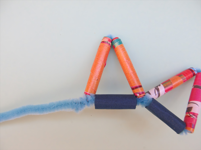 Twist the short end of the pipe cleaner tightly around the long end