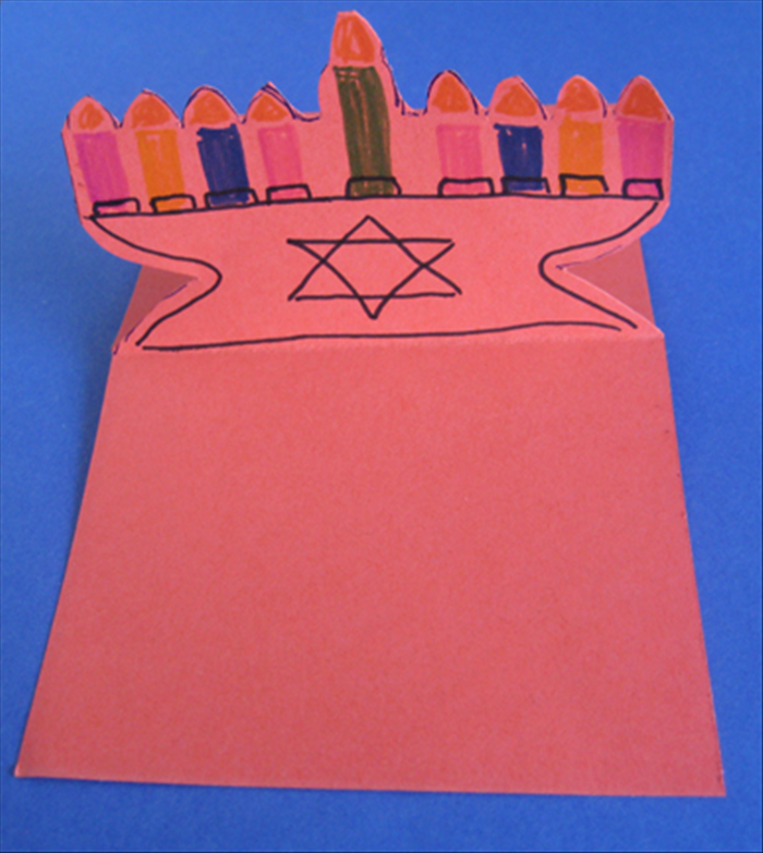Decorate both the front and the back of the menorah with colored markers or glue colored papers