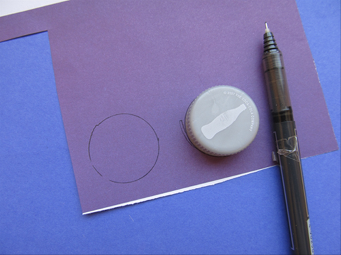 Trace a bottle cap or round object 2 times and cut out the 2 circles