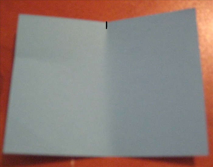 Fold the paper widthwise in half and only pinch the halfway point