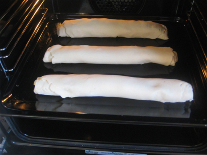 Roll up the dough and squeeze the side ends closed.  
Repeat the process for the other 2 portions of dough.
Place them seam side down on a greased baking sheet
Bake in 325 degrees fahrenheit  oven about 40 minutes or until golden brown.
