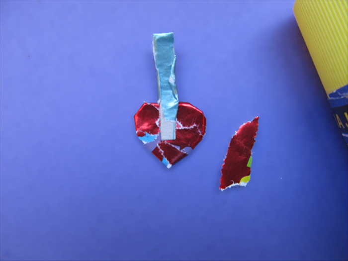 <p> Cover the heart with paper.</p> 
<p> Cut a thin strip and cover it with the same color paper as the bottom of the house.</p> 
<p> Glue it to the heart and cover it with the same color paper as the heart.</p> 
<p>  </p>